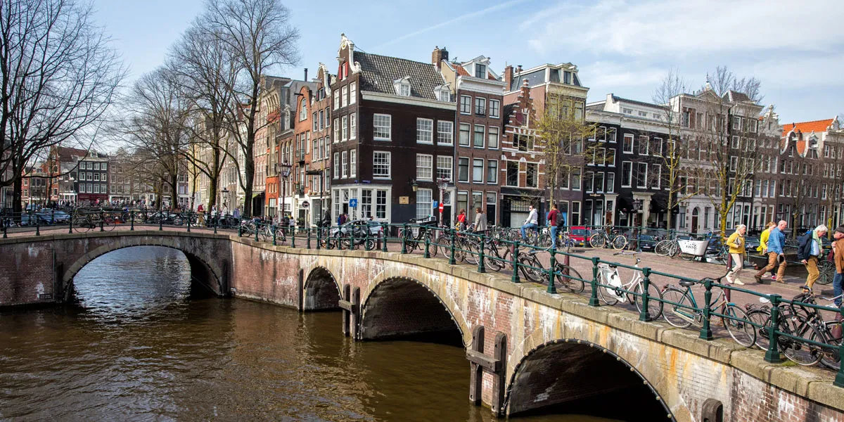 a bridge over a river with bicycles on it