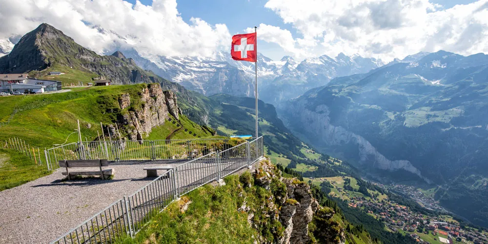 a flag on a pole on a cliff