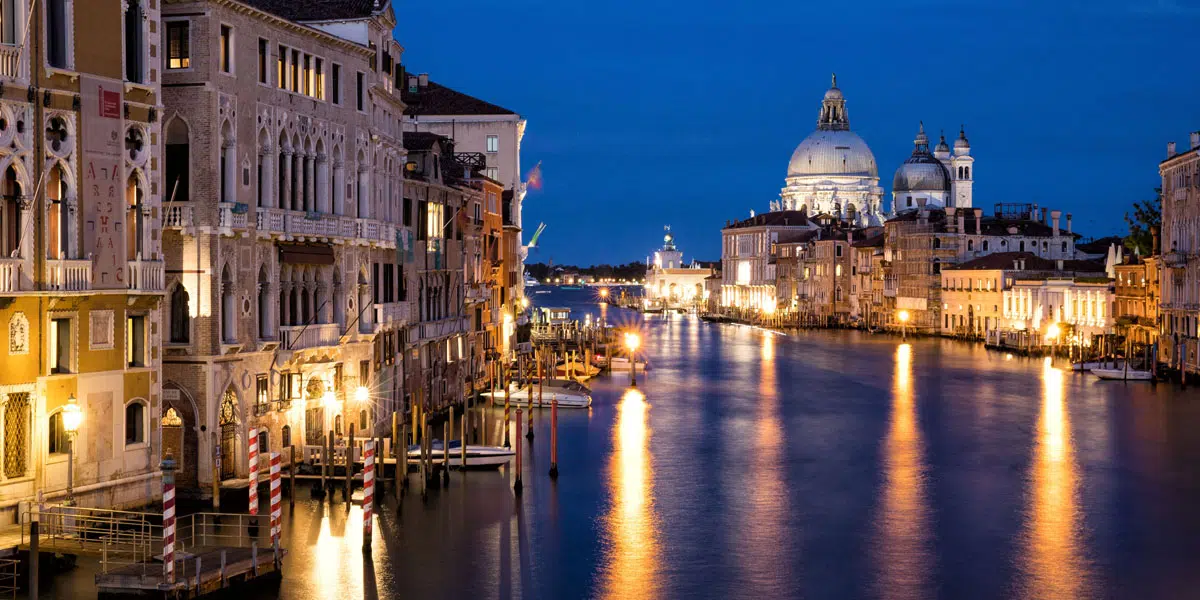 a water way with buildings and a dome